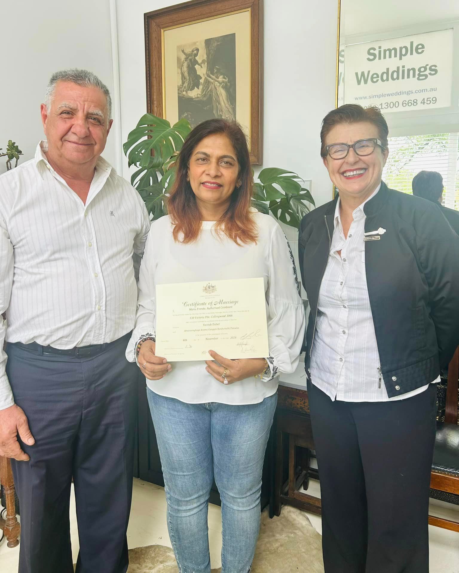 Celebrant with couple signing paperwork in Sydney