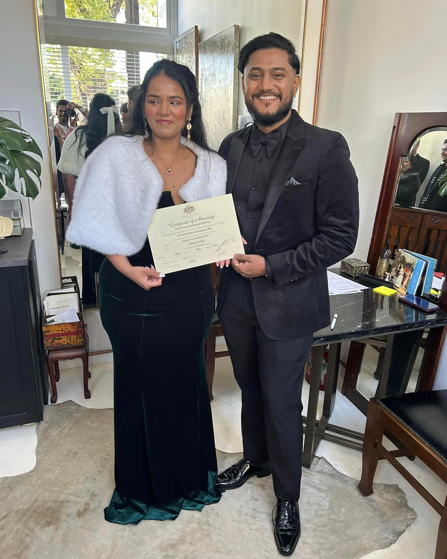 Couple holding wedding certificate