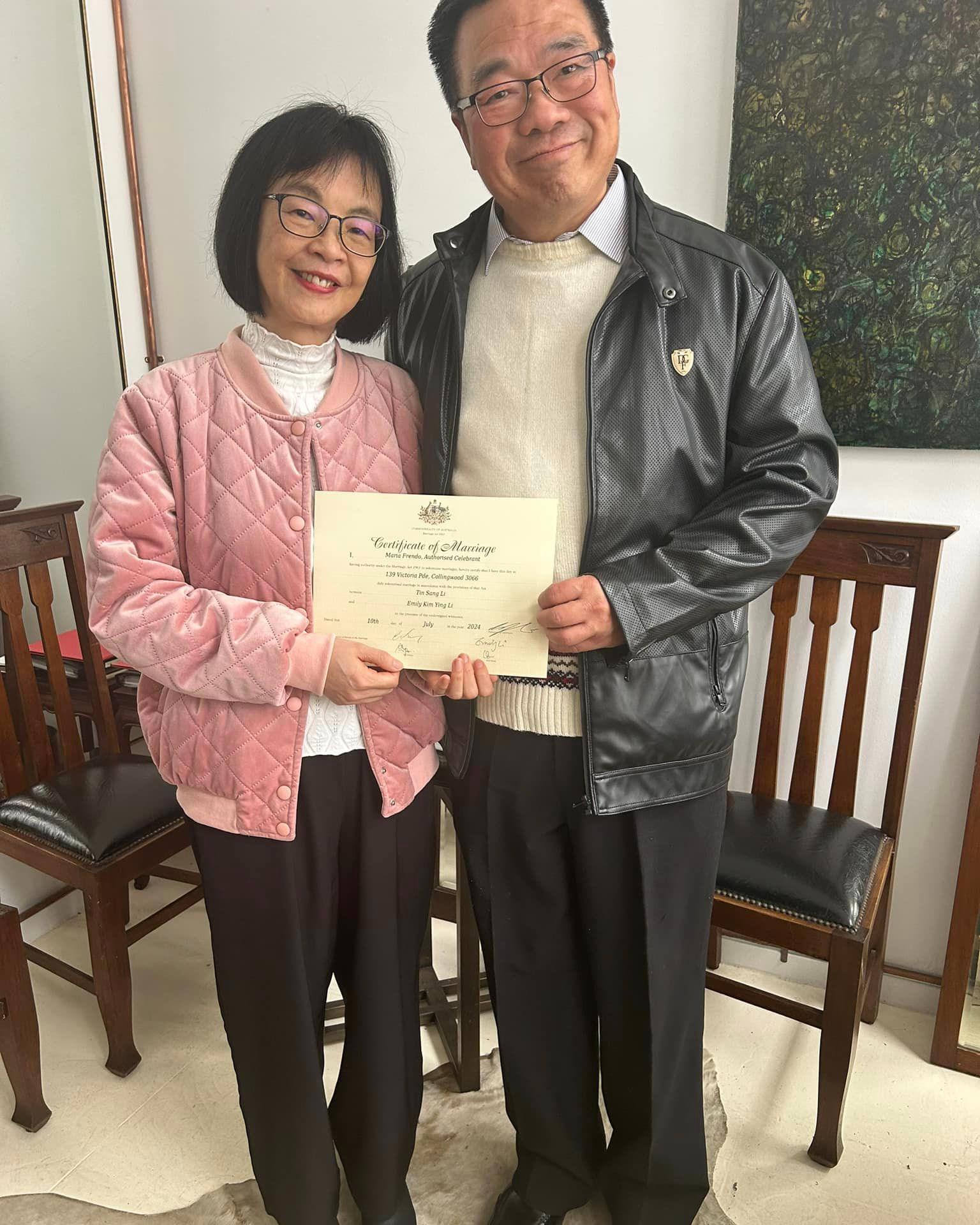 Couple holding wedding certificate