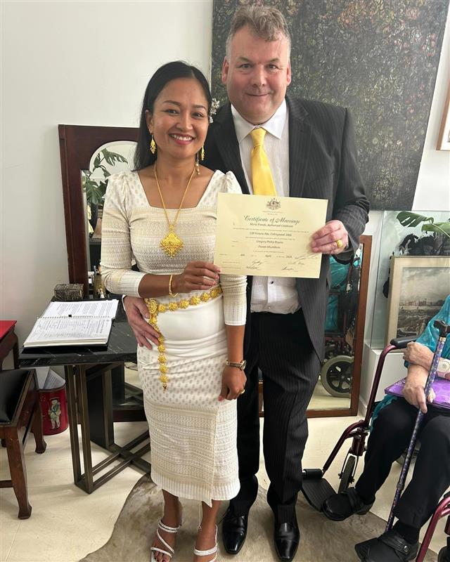 Couple holding wedding certificate